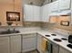 Cozy kitchen with white cabinets, electric stovetop, dishwasher and decorative wall decor at 1600 Long Grove Dr # 411, Mount Pleasant, SC 29464