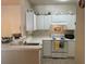 Functional kitchen with white cabinetry, tiled floors, an electric stove, and white countertops at 1600 Long Grove Dr # 411, Mount Pleasant, SC 29464