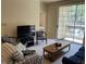 Relax in the living room, offering comfortable seating and a smooth transition to the outdoor space through sliding doors at 1600 Long Grove Dr # 411, Mount Pleasant, SC 29464