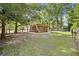 The backyard features an enclosed hot tub, mature trees, and a swing set at 1673 Sulgrave Rd, Charleston, SC 29414