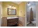 Charming bathroom with a dark wood vanity and a tiled walk-in shower at 1673 Sulgrave Rd, Charleston, SC 29414