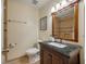 Well-maintained bathroom features a dark granite vanity, decorative mirror, and shower at 1673 Sulgrave Rd, Charleston, SC 29414