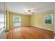 Spacious bedroom featuring hardwood floors, two large windows, and a ceiling fan at 1673 Sulgrave Rd, Charleston, SC 29414