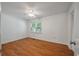Neutral bedroom featuring wood floors, a ceiling fan, and bright window at 1673 Sulgrave Rd, Charleston, SC 29414