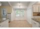 Bright dining area with tile floor, double window, and a convenient layout open to the kitchen at 1673 Sulgrave Rd, Charleston, SC 29414