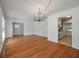 Spacious dining area featuring hardwood floors, neutral paint, modern lighting and a glimpse of the kitchen at 1673 Sulgrave Rd, Charleston, SC 29414