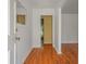 View of the entryway with hardwood floors, crisp white walls and a glimpse of the home's interior at 1673 Sulgrave Rd, Charleston, SC 29414