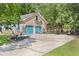 A two-car garage with blue doors is located next to a basketball court and a flower bed at 1673 Sulgrave Rd, Charleston, SC 29414