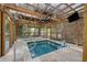 A beautiful screened-in hot tub features travertine floors, a ceiling fan, and a wall-mounted television at 1673 Sulgrave Rd, Charleston, SC 29414