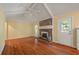 Bright living room boasting hardwood floors, brick fireplace, vaulted ceiling and ample natural light at 1673 Sulgrave Rd, Charleston, SC 29414