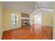 Bright living room boasting hardwood floors, brick fireplace, vaulted ceiling and ample natural light at 1673 Sulgrave Rd, Charleston, SC 29414