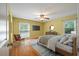 Cozy main bedroom with hardwood floors, a ceiling fan, and a comfortable seating area at 1673 Sulgrave Rd, Charleston, SC 29414