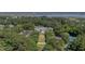 Expansive aerial view of a grand estate featuring lush grounds, tennis courts, and a waterfront view at 1709 Blalock St, Mount Pleasant, SC 29466