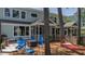 Outdoor space with screened-in porch, fire pit, blue Adirondack chairs, and a hammock at 1709 Blalock St, Mount Pleasant, SC 29466