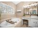 Bathroom including a soaking tub, framed mirror, granite countertop, and a vessel sink at 1709 Blalock St, Mount Pleasant, SC 29466