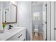 Clean bathroom featuring a bright white vanity with stone countertop and views into the toilet room at 1709 Blalock St, Mount Pleasant, SC 29466