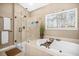 Well lit bathroom featuring glass shower enclosure and soaking tub at 1709 Blalock St, Mount Pleasant, SC 29466