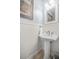 Stylish half bath with pedestal sink, wainscoting and neutral decor, providing a clean and sophisticated feel at 1709 Blalock St, Mount Pleasant, SC 29466