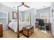 Calm bedroom featuring a four poster bed, ceiling fan, sitting space, and natural light at 1709 Blalock St, Mount Pleasant, SC 29466