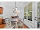 Cozy dining area with a view, showcasing a round table, wood floors and access to the outdoor patio at 1709 Blalock St, Mount Pleasant, SC 29466