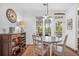 Bright dining area featuring a round table, rustic sideboard, and large windows with a view to the backyard at 1709 Blalock St, Mount Pleasant, SC 29466