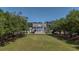 Grand Southern-style home featuring a manicured front lawn and stately columns and circular drive at 1709 Blalock St, Mount Pleasant, SC 29466