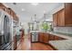 Spacious kitchen featuring stainless steel appliances, granite countertops and hardwood floors with view to dining area at 1709 Blalock St, Mount Pleasant, SC 29466