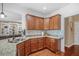 Well-lit kitchen featuring granite countertops, wood cabinets, and stainless steel sink, perfect for modern living at 1709 Blalock St, Mount Pleasant, SC 29466