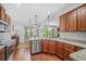 Modern kitchen with granite countertops, stainless steel appliances, and wood floors, ideal for culinary adventures at 1709 Blalock St, Mount Pleasant, SC 29466