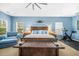 Large main bedroom showcasing a tray ceiling, sitting area, and exercise bike at 1709 Blalock St, Mount Pleasant, SC 29466