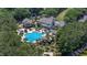Aerial view of a neighborhood pool and clubhouse surrounded by palm trees, perfect for relaxation and recreation at 1709 Blalock St, Mount Pleasant, SC 29466
