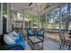 Inviting screened porch boasts string lights, comfortable seating, and peaceful views of the surrounding trees and greenery at 1709 Blalock St, Mount Pleasant, SC 29466