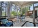 Cozy screened porch featuring lake views, outdoor seating, and charming decor for relaxing and entertaining at 1709 Blalock St, Mount Pleasant, SC 29466