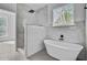 Bathroom with a glass shower, standalone tub and a window view at 1851 Oleander Ct, Charleston, SC 29414