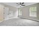Inviting bedroom featuring neutral carpet, a ceiling fan, and two windows offering ample natural light at 1851 Oleander Ct, Charleston, SC 29414