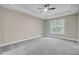 Spacious primary bedroom features plush carpet, neutral walls and a ceiling fan at 1851 Oleander Ct, Charleston, SC 29414