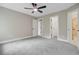 Neutral bedroom with carpet, ceiling fan, and open doorways, creating a versatile and spacious atmosphere at 1851 Oleander Ct, Charleston, SC 29414