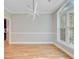 Spacious dining room with hardwood floors, modern chandelier, and a large window at 1851 Oleander Ct, Charleston, SC 29414