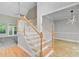 Inviting entryway with hardwood floors, a staircase with wooden railings, and open access to a living area at 1851 Oleander Ct, Charleston, SC 29414
