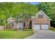 Charming brick home with a well-manicured lawn, mature tree, and attached two-car garage at 1851 Oleander Ct, Charleston, SC 29414
