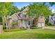 Inviting brick home with a lush green lawn and mature tree, offering a desirable curb appeal at 1851 Oleander Ct, Charleston, SC 29414