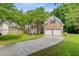 Lovely home boasts a brick facade, well-kept lawn, mature trees, and an attached two-car garage at 1851 Oleander Ct, Charleston, SC 29414