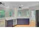 Modern kitchen featuring stainless steel appliances, hardwood floors, and a sink area with backyard views at 1851 Oleander Ct, Charleston, SC 29414
