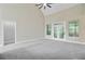 Spacious living room with vaulted ceilings, neutral colors, and access to outdoor balcony at 1851 Oleander Ct, Charleston, SC 29414