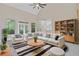 Spacious living room boasts high ceilings, a ceiling fan, built-in shelving, and a comfortable sectional sofa at 1851 Oleander Ct, Charleston, SC 29414