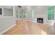 Inviting living space with fireplace, hardwood flooring, and abundant natural light at 1851 Oleander Ct, Charleston, SC 29414