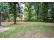 Large backyard with ample space for outdoor activities, surrounded by lush greenery and framed by a classic wooden fence at 19 Milano Ct, Hanahan, SC 29410