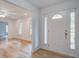 Bright foyer featuring a white door with sidelights and views into the open-concept living space at 19 Milano Ct, Hanahan, SC 29410