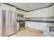 Modern kitchen features stainless steel appliances, granite counters and white cabinetry at 19 Milano Ct, Hanahan, SC 29410