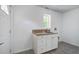 This laundry room offers a single sink vanity with granite countertops at 19 Milano Ct, Hanahan, SC 29410